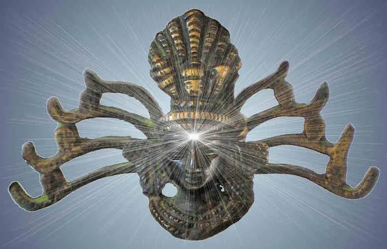 A bronze Shiva head, its hair flying out, with rays bursting from the brow